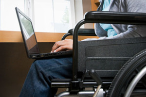applying for disability benefits - patient with laptop in wheel chair